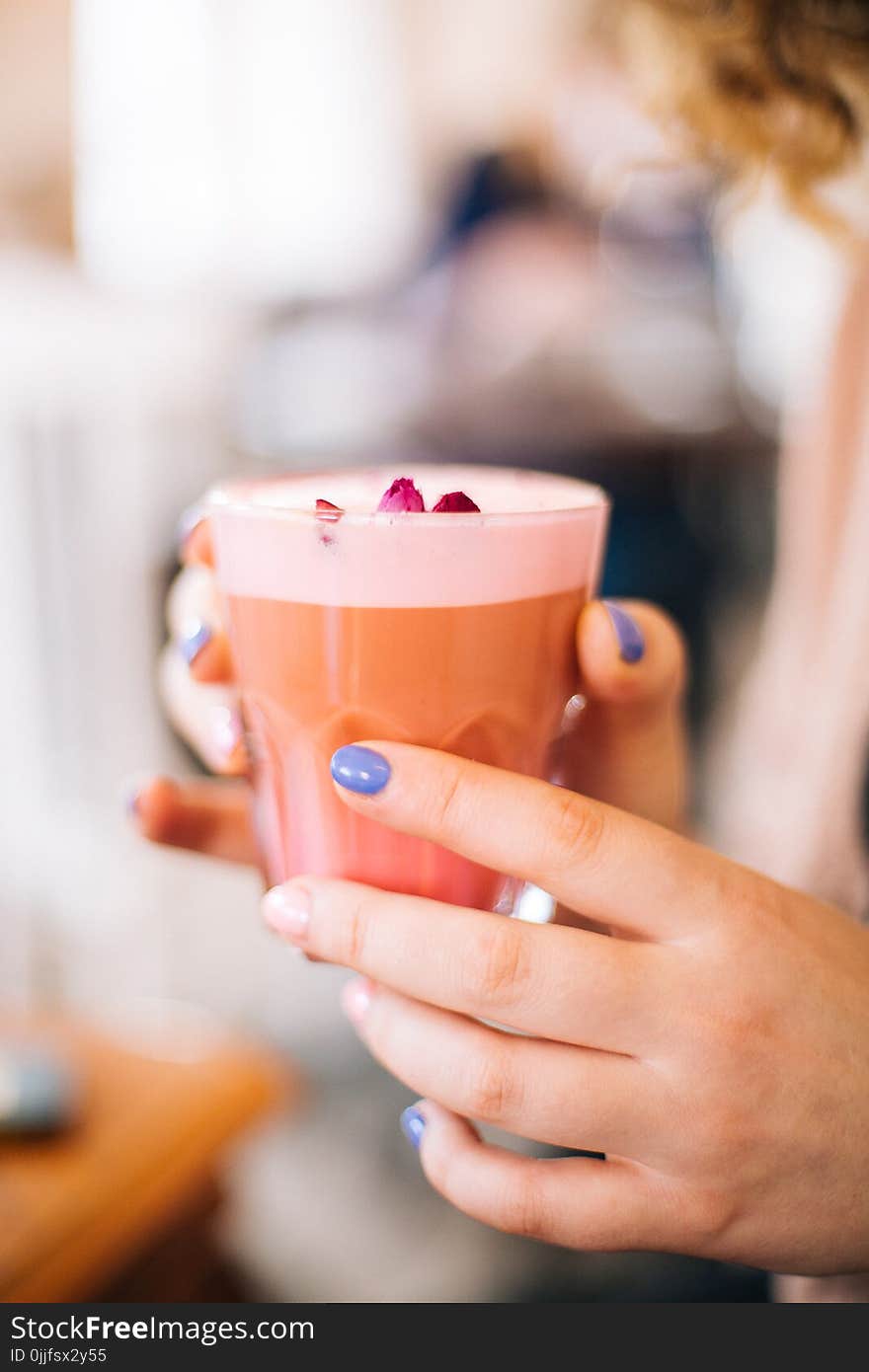 Selective Focus Photo of Person Holding Cup