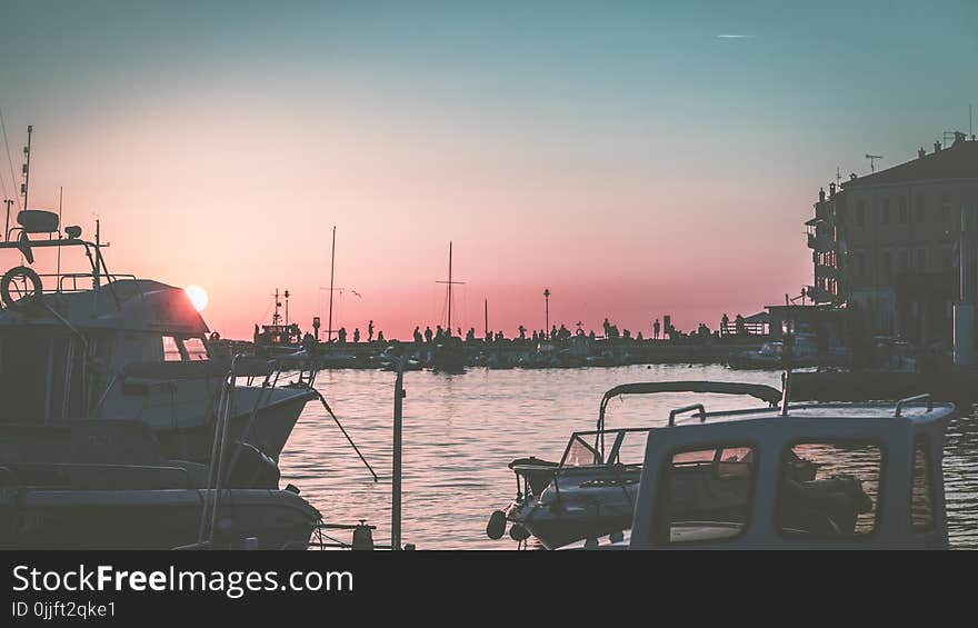 White Yacht on Body of Water during Sunset