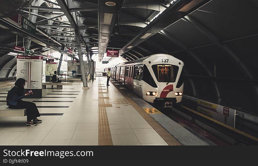 Indoor Train Station With Few People Waiting for the Train