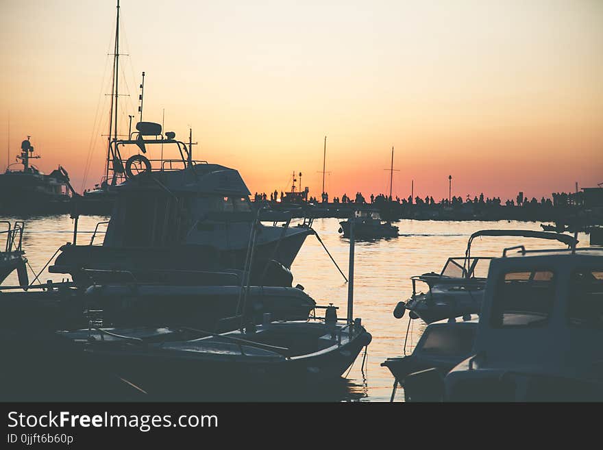 Several Boats on Calm Water during Golden Hour