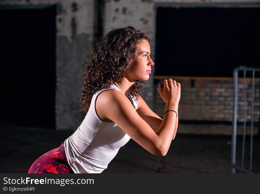 Young female athlete exercising at night, close up. Young female athlete exercising at night, close up.