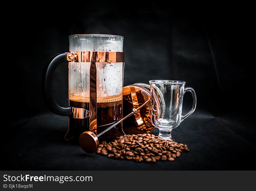 Coffee Beans Beside Coffee Press and Glass Cup