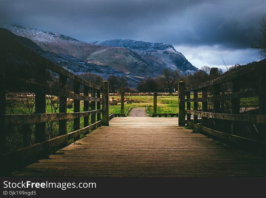 Brown Wooden Bridge Near Mountain at Daytime