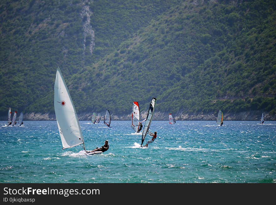 Man in Black Top Ridding Sailboat