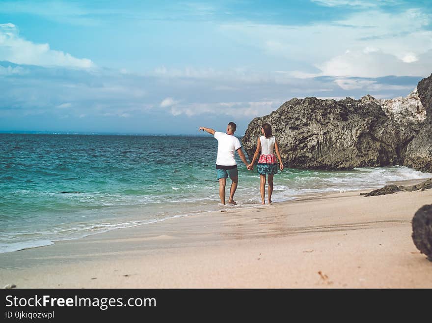 Two Person Walking on Sea Shore