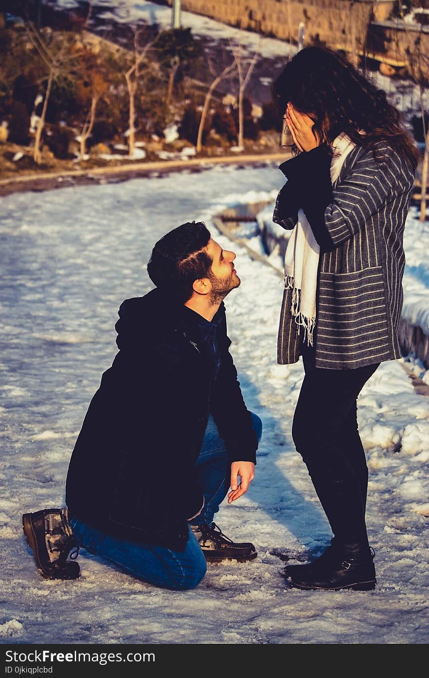 Man Kneeling in Front of Woman