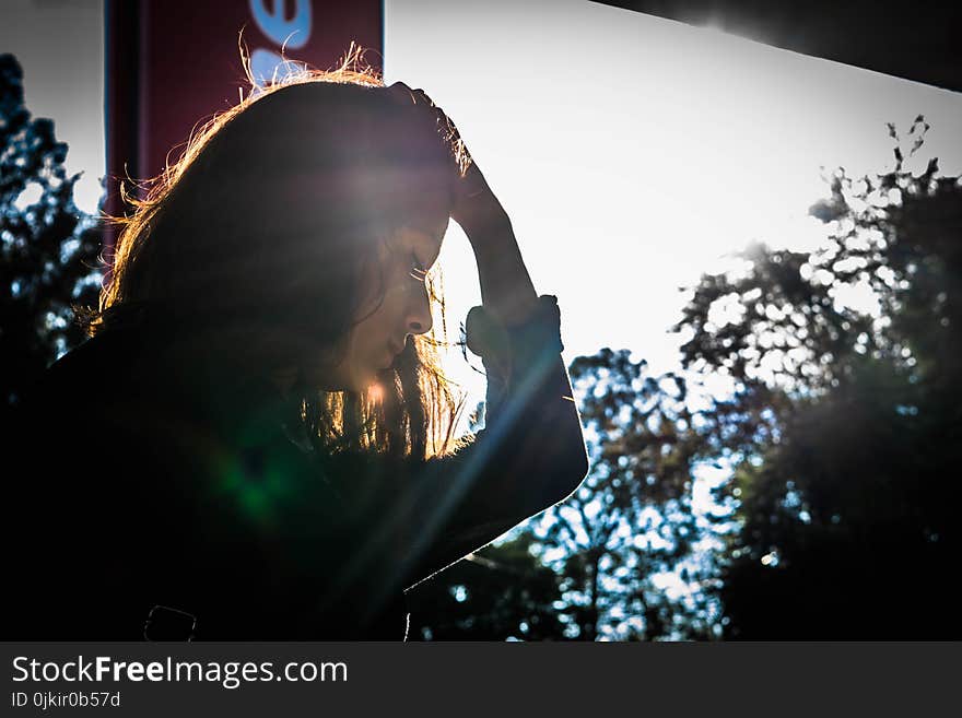 Woman Looking Holding While Holding Head With Left Hand