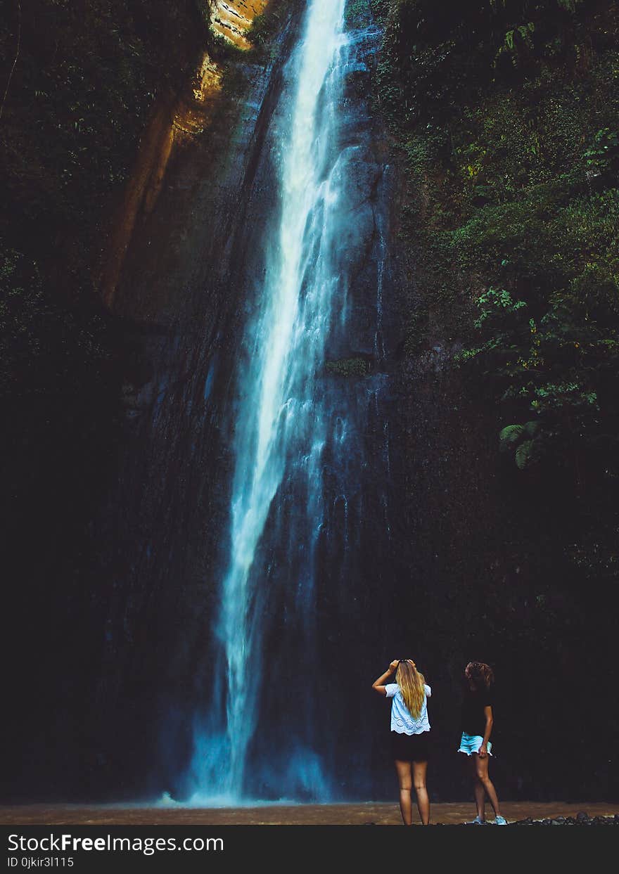 Two Women Near Waterfalls