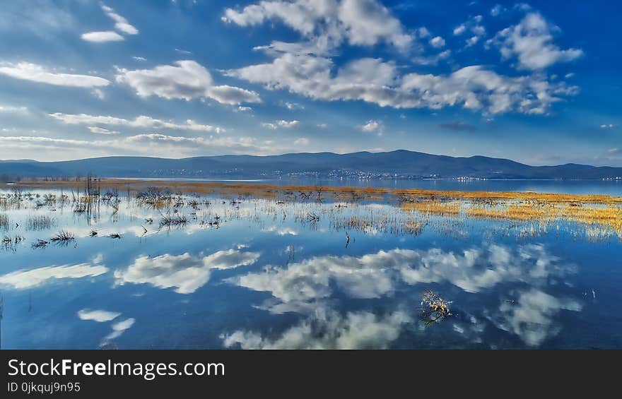 reflection of clouds at the wetland of Lake Doriani on a winter