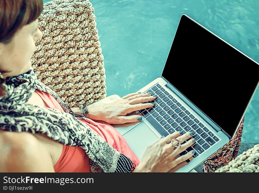 Woman Wearing Pink Top With Macbook on Lap