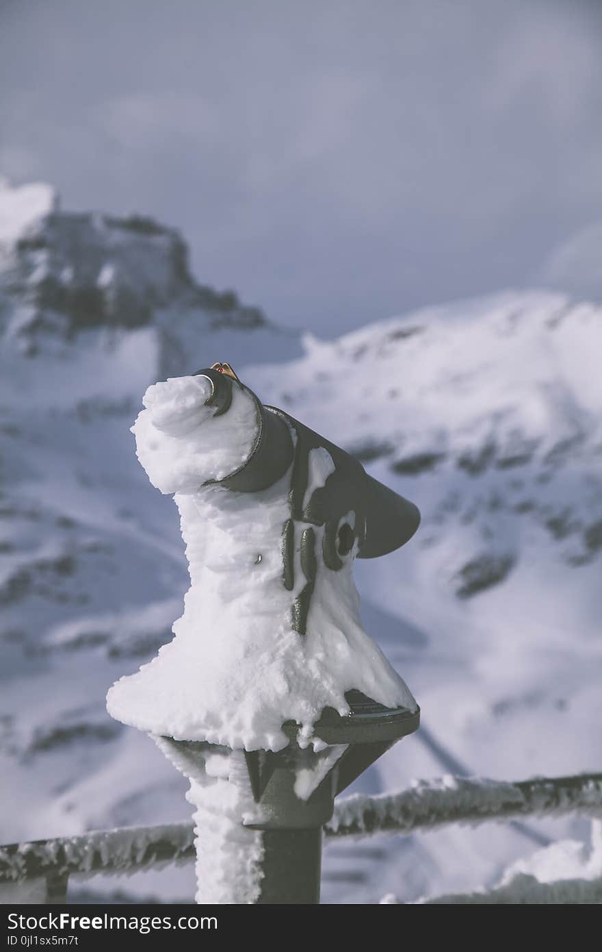 Selective Focus Photography of Black Camera Covered With Snow