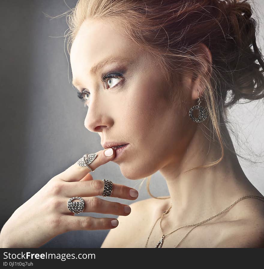 Woman Wearing Rings and Earrings