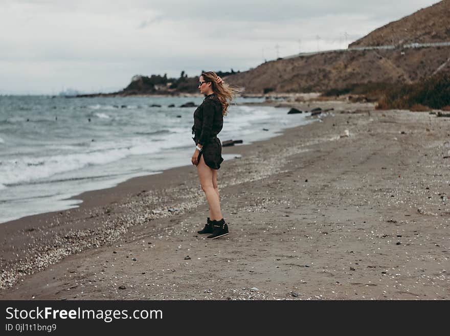 Woman Standing on Seashore