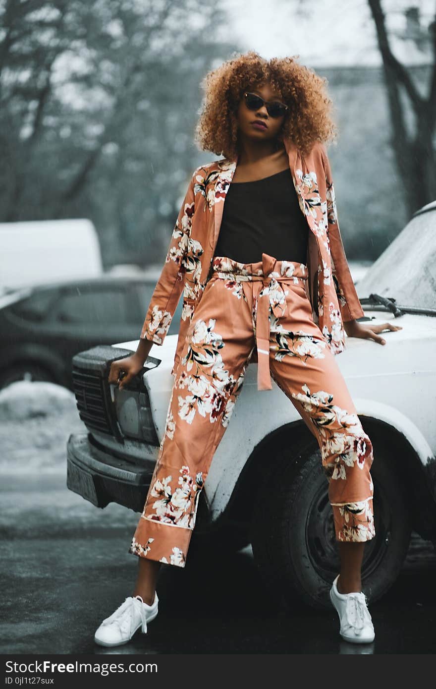 Woman Wearing Brown-and-white Cardigan With Matching Pants Sitting in White Vehicle