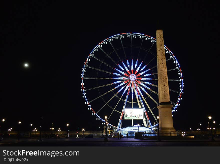 Photo of London Eye, London Near Brown Concrete Monument during Night Time