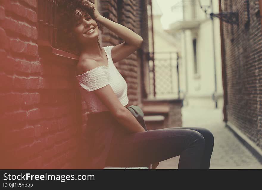 Woman Wearing White Off-shoulder Shirt and Blue Denim Jens