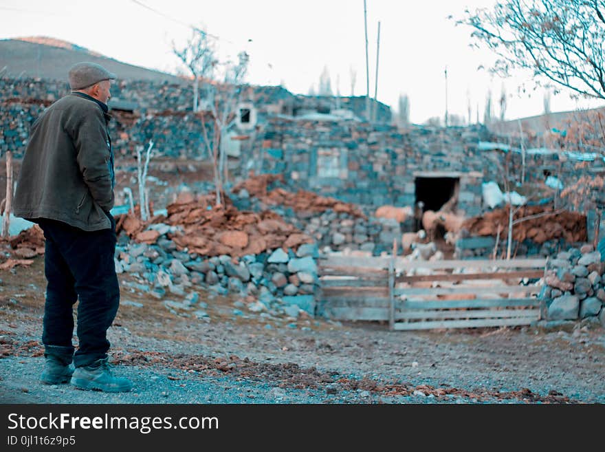 Man in Gray Jacket Standing on Rocks