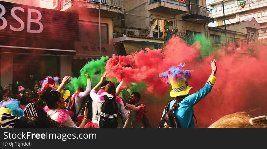 People Spraying Assorted Color Of Smoke