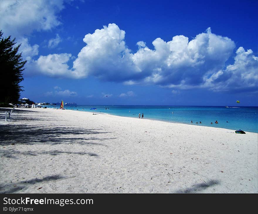 A beautiful white sandy beach in the tropical island of Cayman Island in the Caribbean. A beautiful white sandy beach in the tropical island of Cayman Island in the Caribbean.