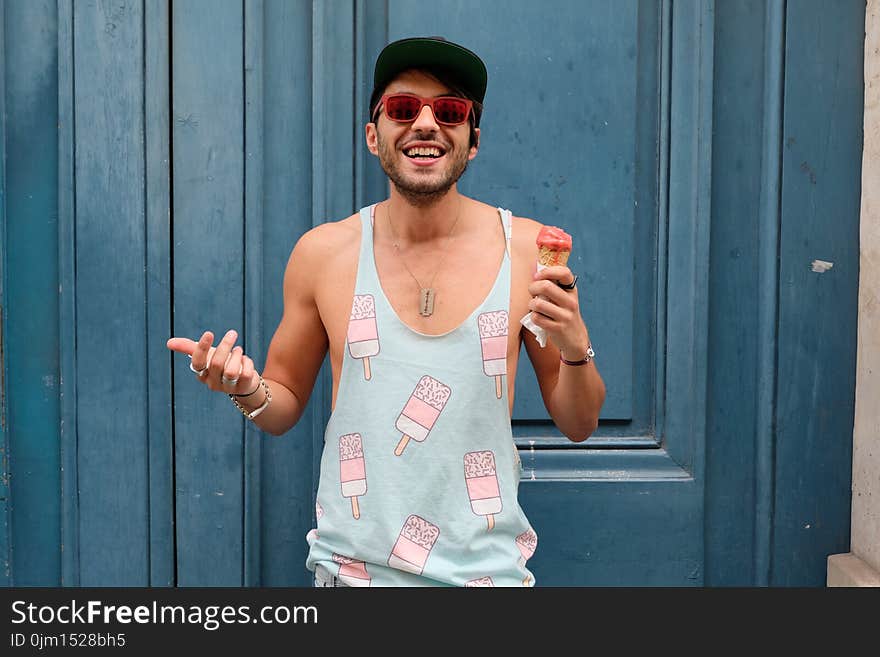 Person in Teal Ice Cream Print Tank Top Holds Ice Cream