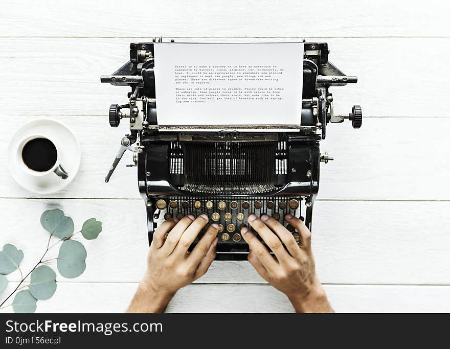 Person Using Typewriter on White Surfac