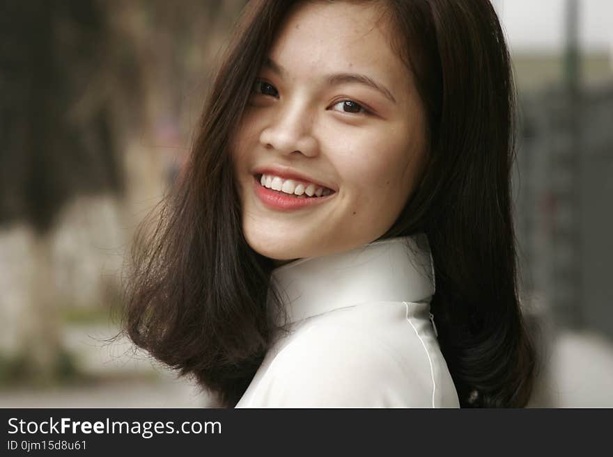 Smiling Woman Wearing White Turtleneck Top