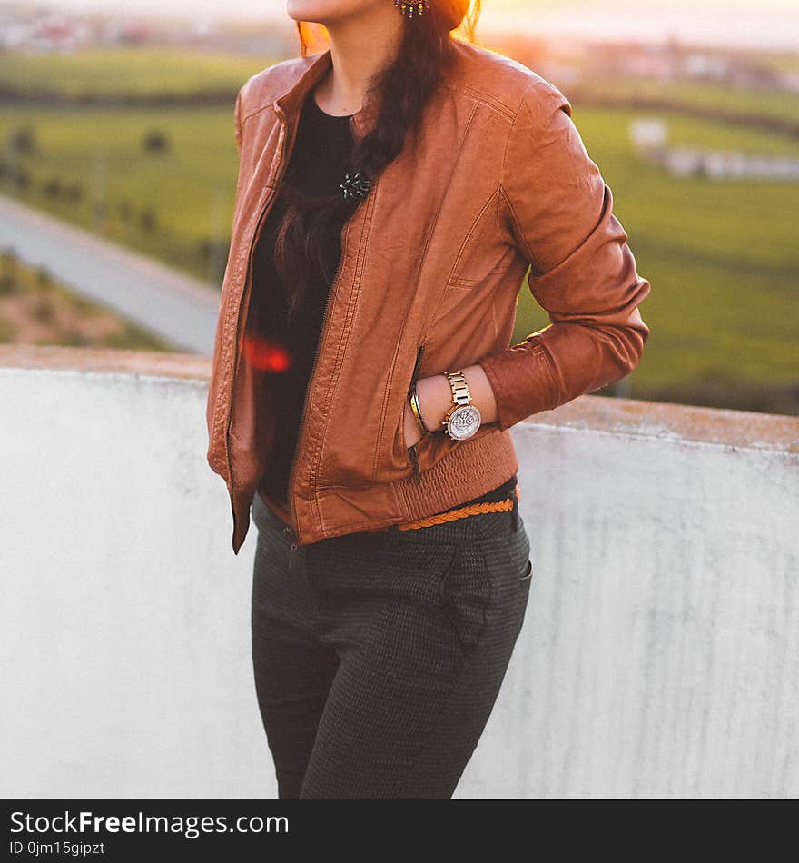 Woman Wearing Brown Leather Jacket and Black Pants