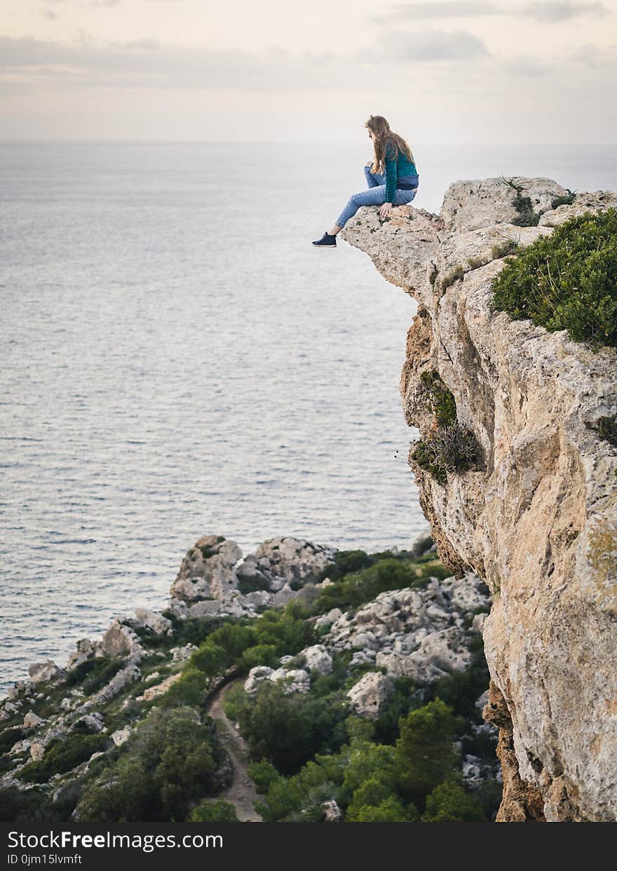 Woman Sitting on Mountain