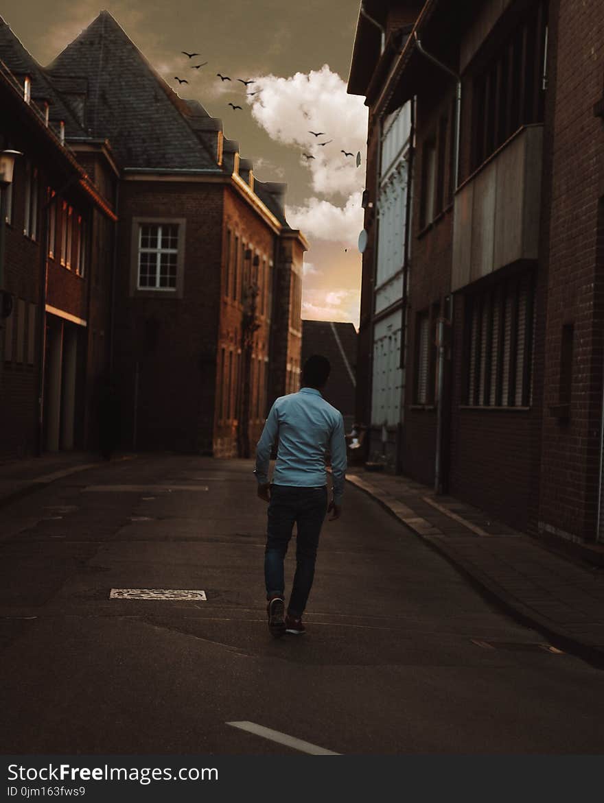 Man Walking Alone in the Street of Town