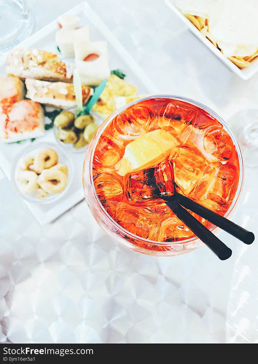 Photo Of Clear Drinking Glass Filled With Liquid Beside Food On Table