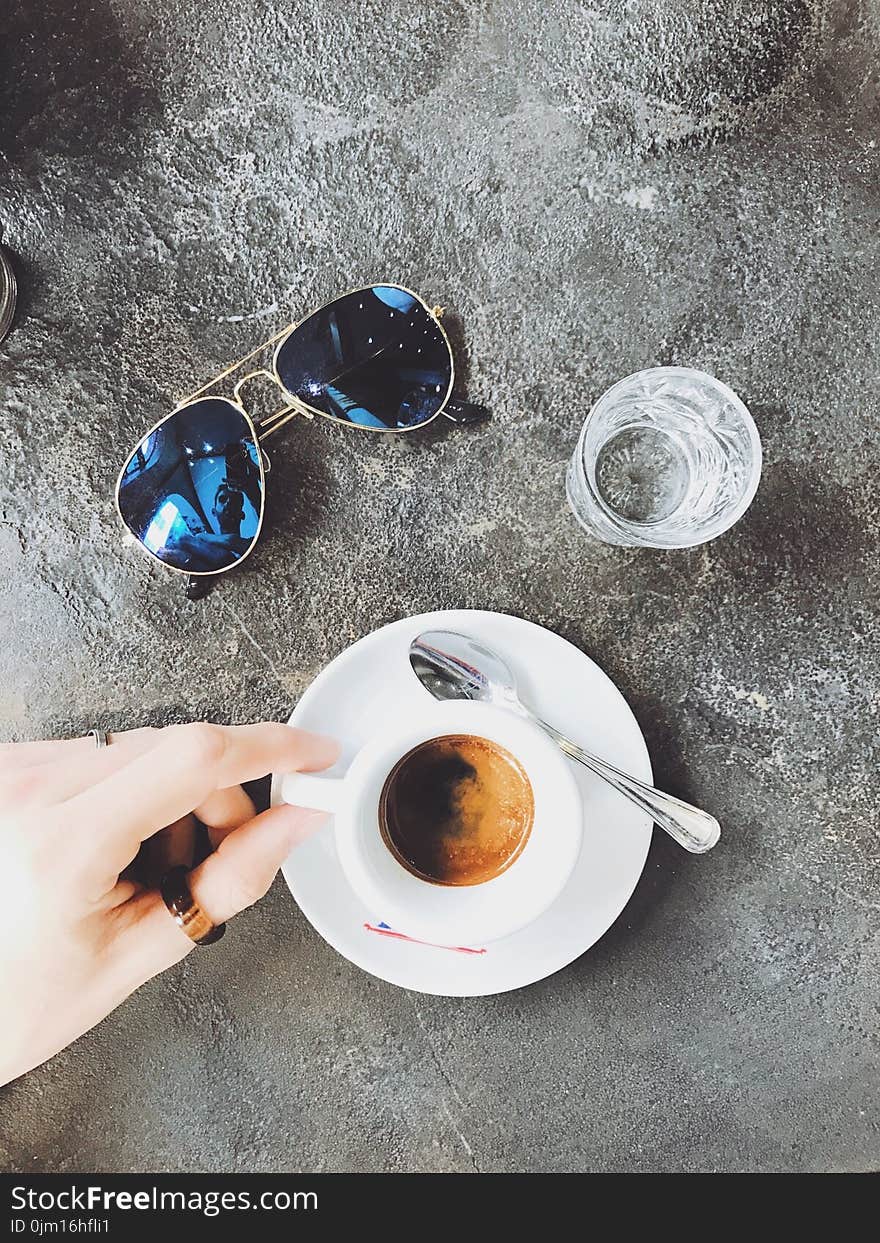 Person Holding White Ceramic Cup Filled With Coffee