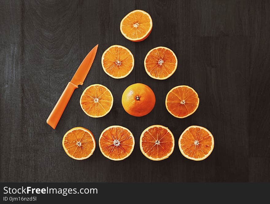 Sliced Orange Fruit With Knife