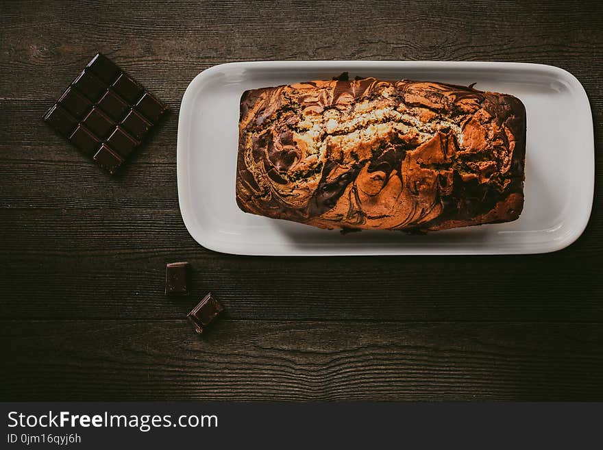 Chocolate Cake In White Plate Beside Chocolate Bars