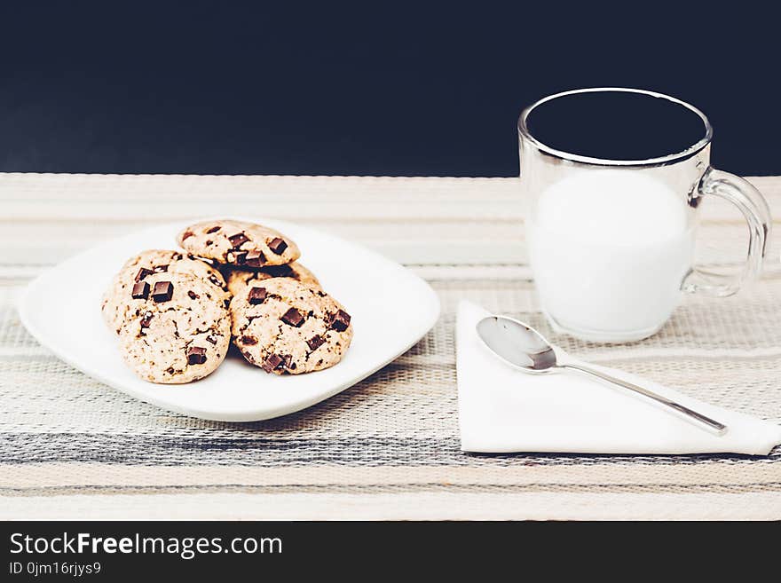 Photo Of Clear Mug Beside Plate With Cookies