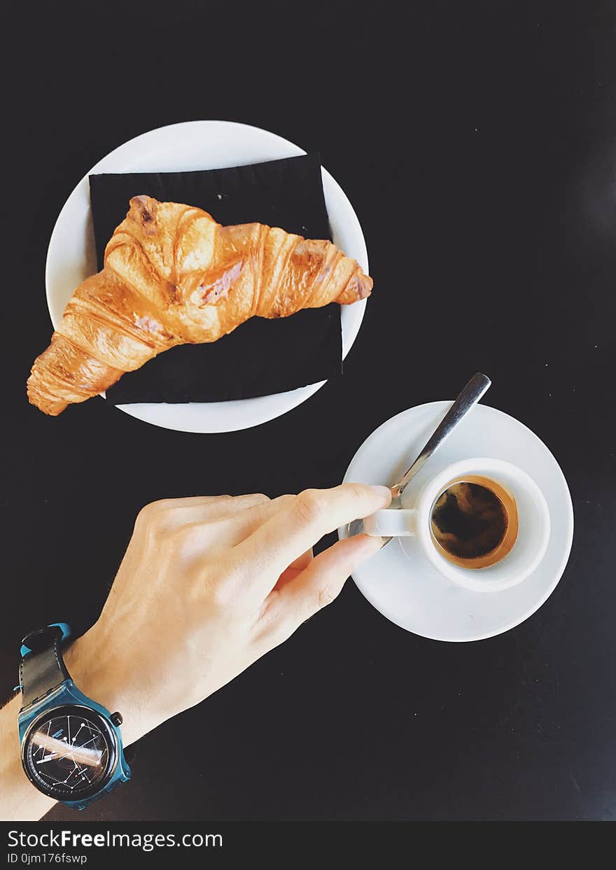 Person Holding White Ceramic Cup