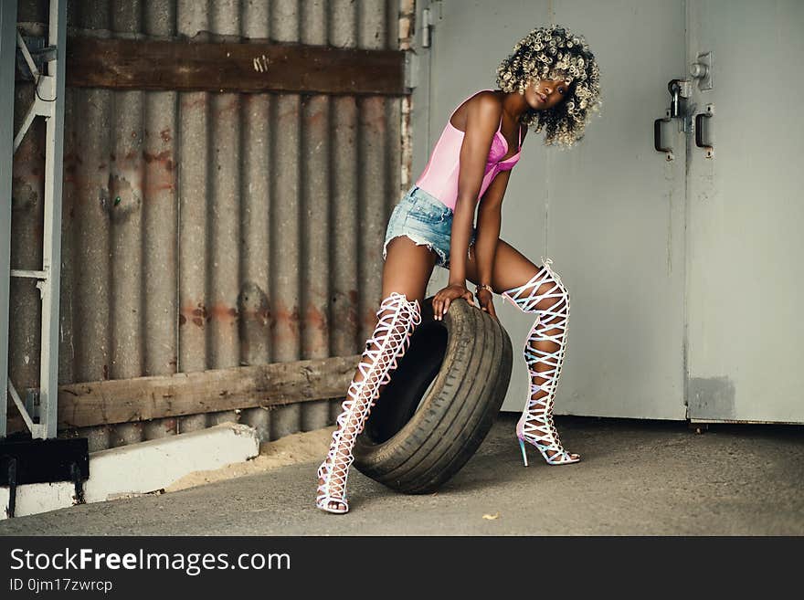 Woman Holding Vehicle Tire