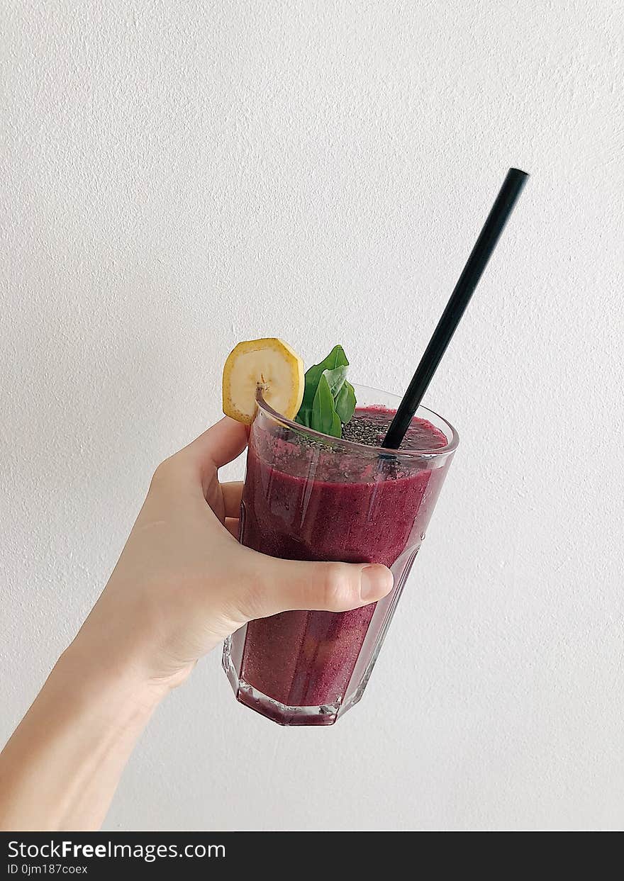 Person&#x27;s Holding Fruit Drink