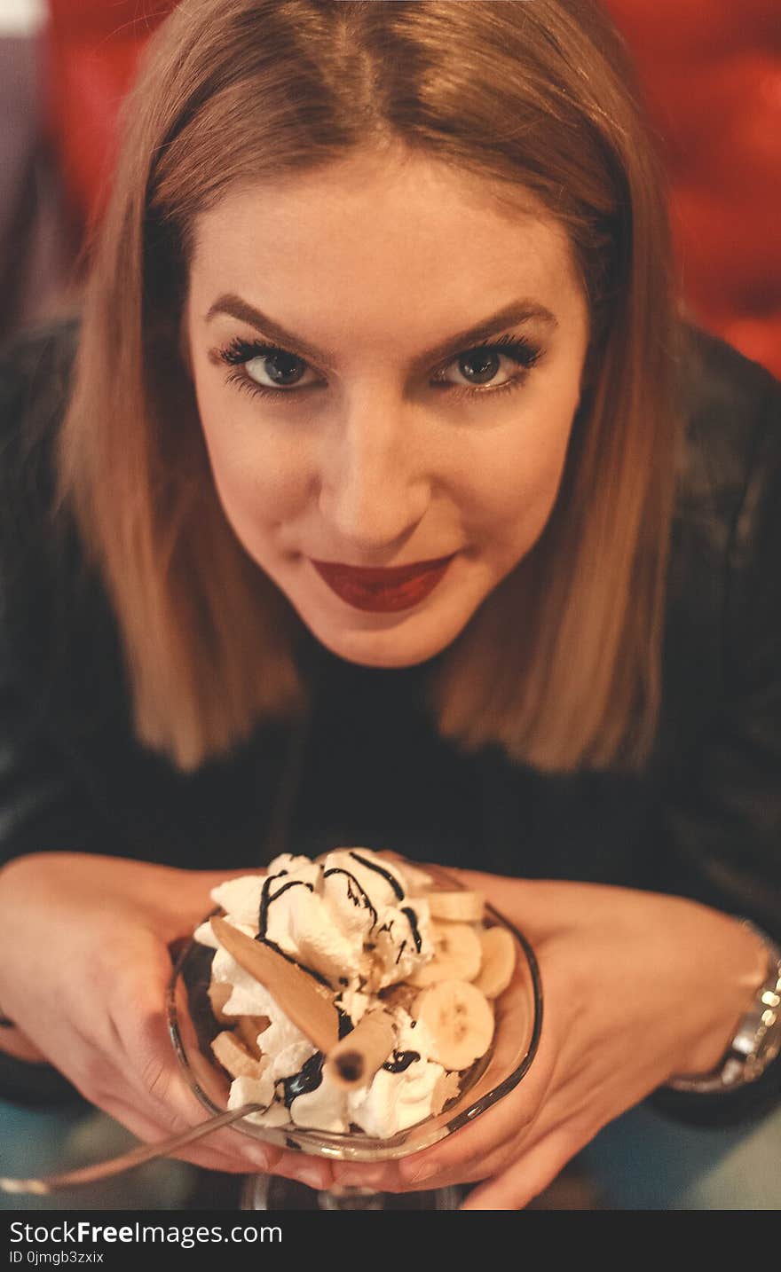 Woman Looking on Camera Holding Bowl With Ice Cream