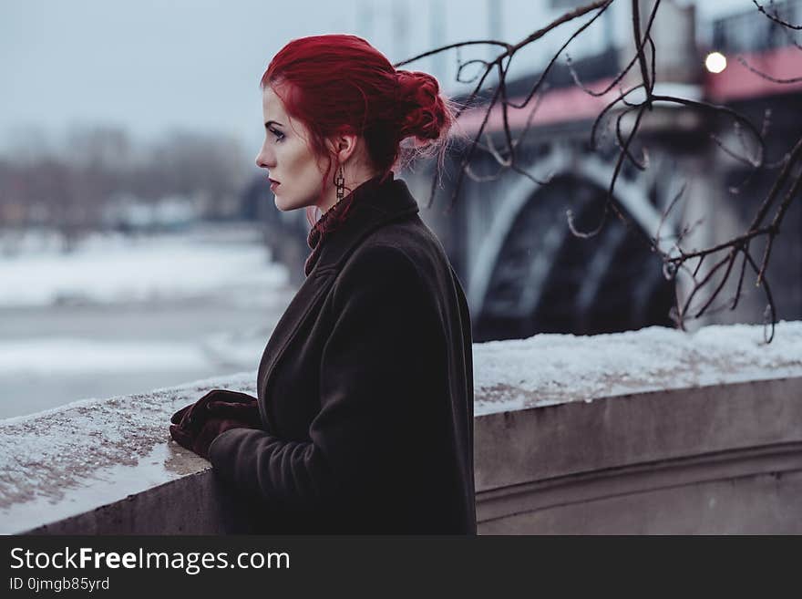 Woman Wearing Black Coat Standing In-front of Balcony