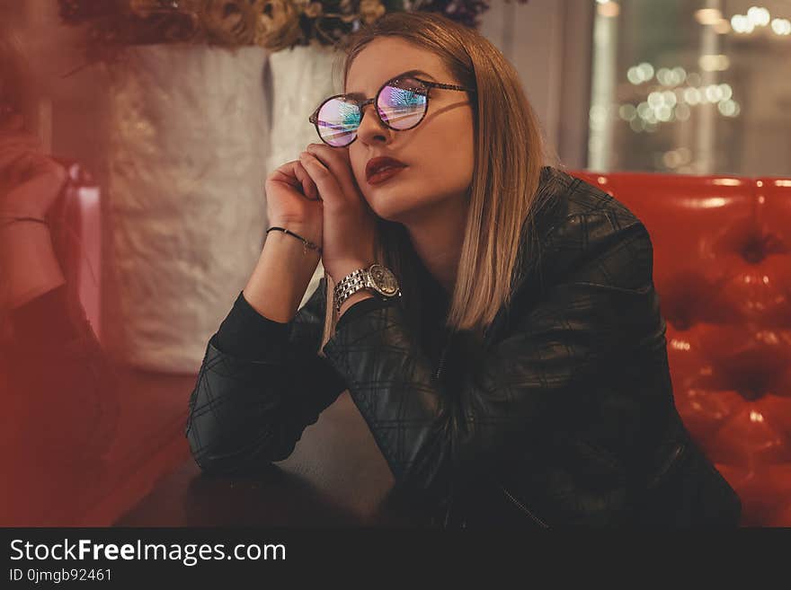 Woman Wearing Eyeglasses Sitting Down