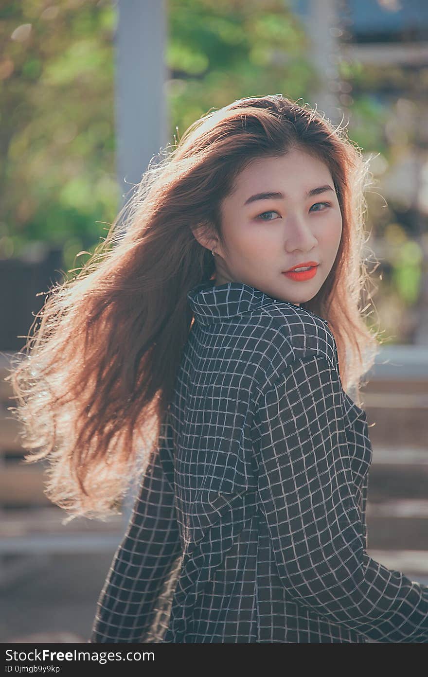 Closeup Photo of a Woman Wearing Black and White Plaid Blazer