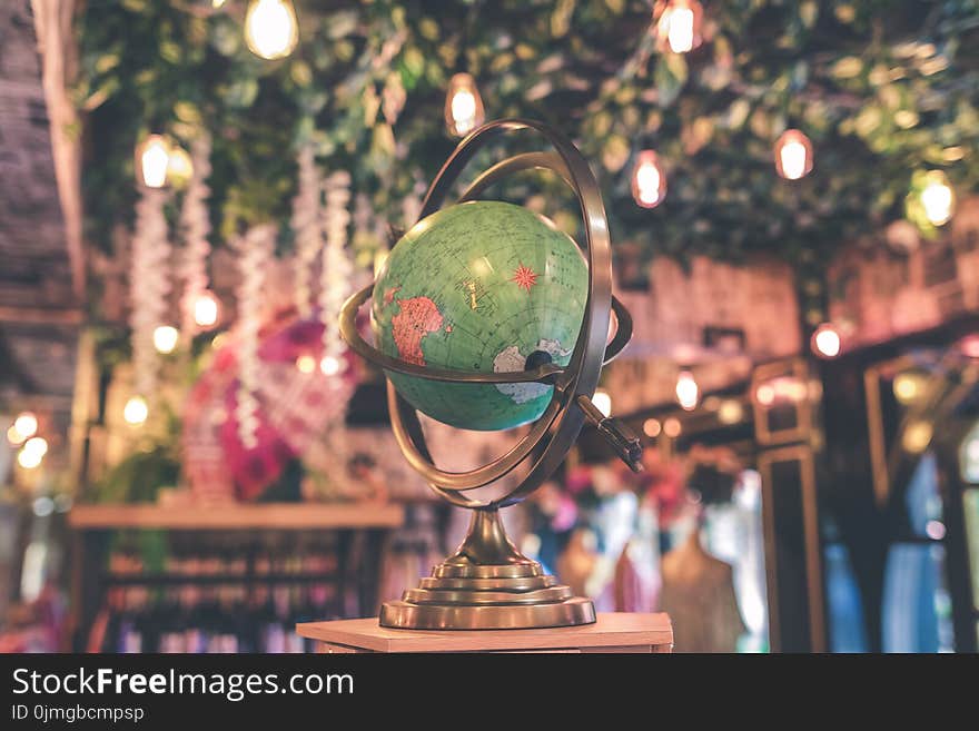 Selective Focus Photo of Armillary Globe