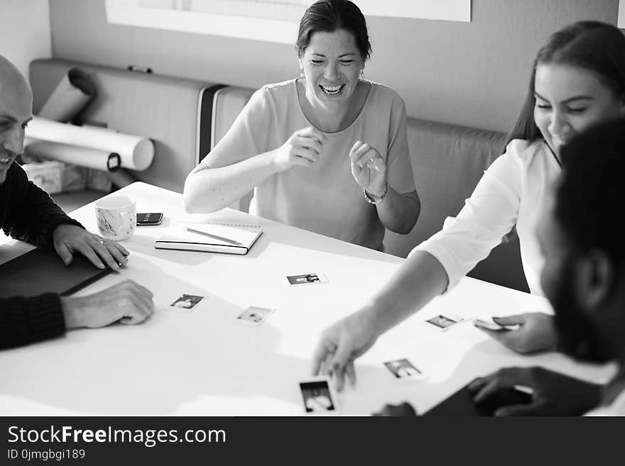 Grayscale Photography of Four Person Having A Discussion