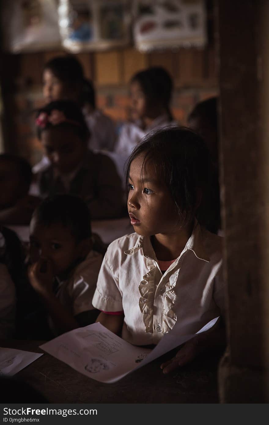 Close Up Photo of Girl Holding Paper