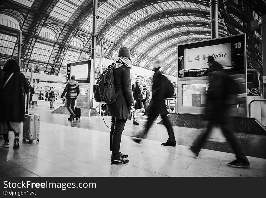 Time Lapse Grayscale Photograph of People Pass Through Inside Transportation Terminal