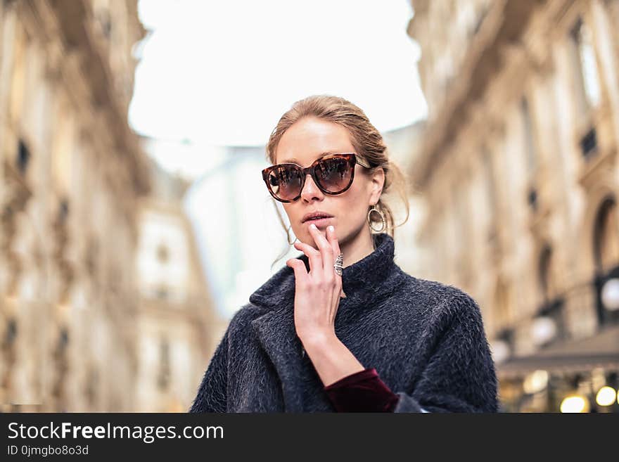 Woman Wearing Black Coat and Brown Framed Sunglasses