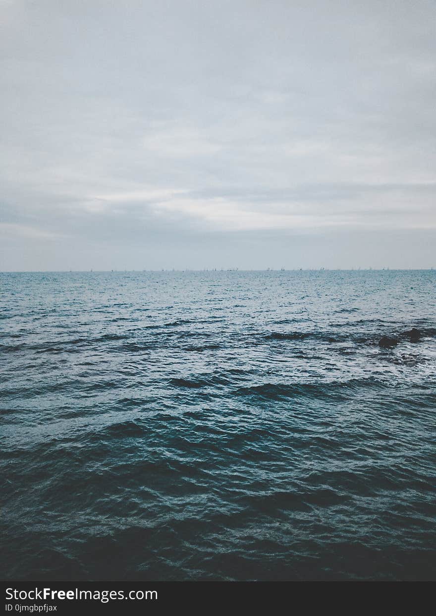 Ocean Under Cloudy Sky