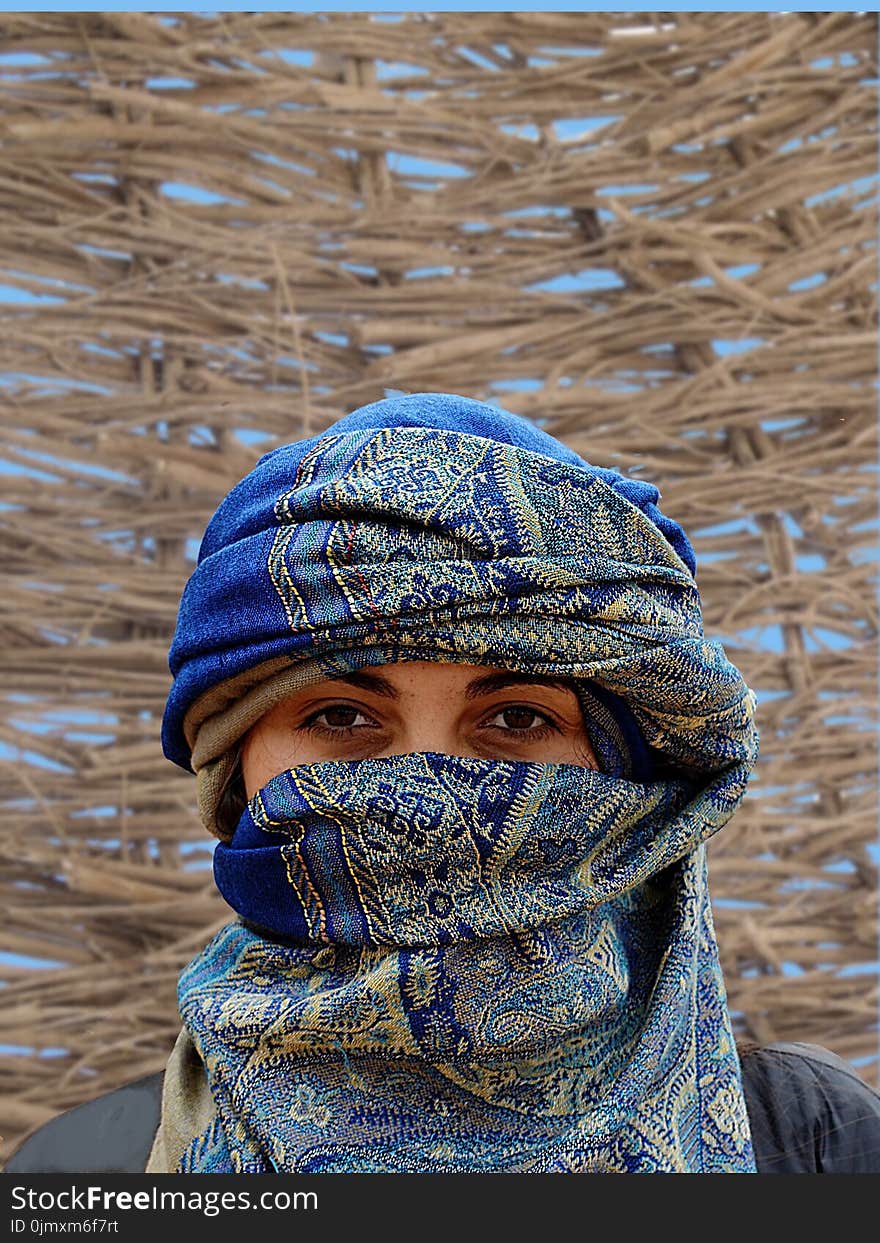 Person Wearing Blue and Brown Hijab Veil