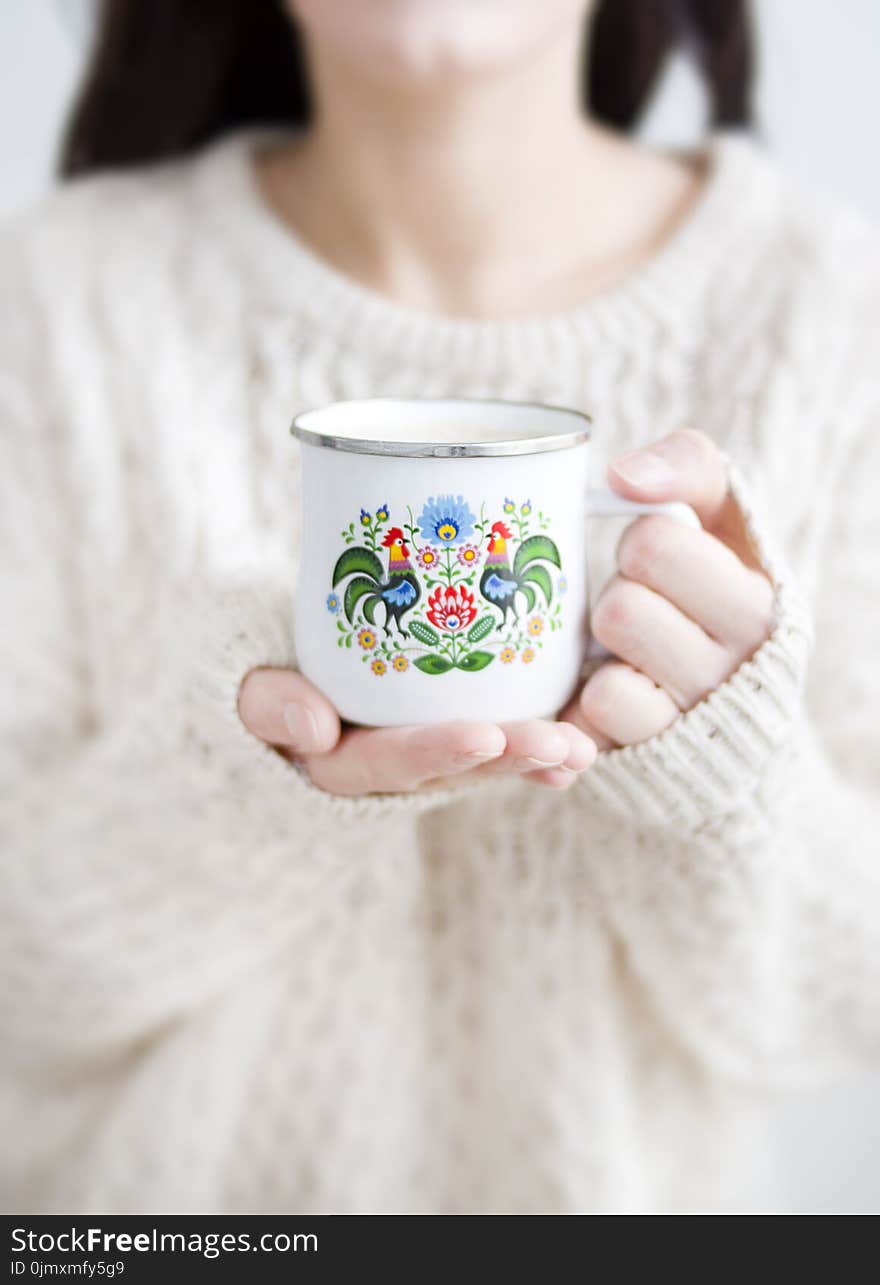 Photo of a Person Holding a Cup