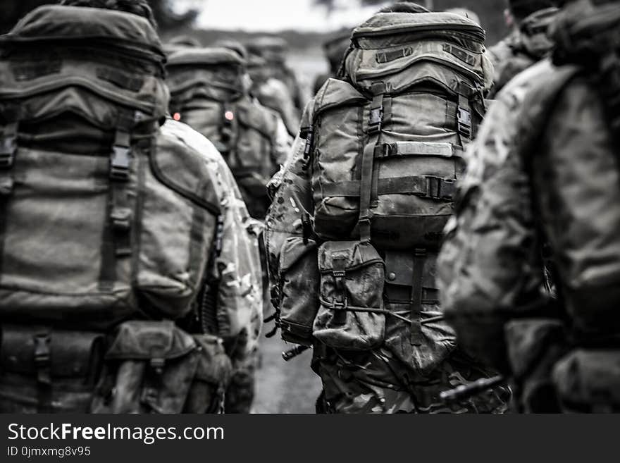 Group of People With Camouflage Backpack